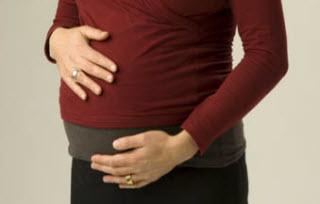 Image of pregnant lady holding her stomach